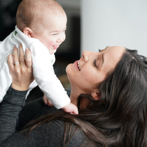 smiling baby with mother