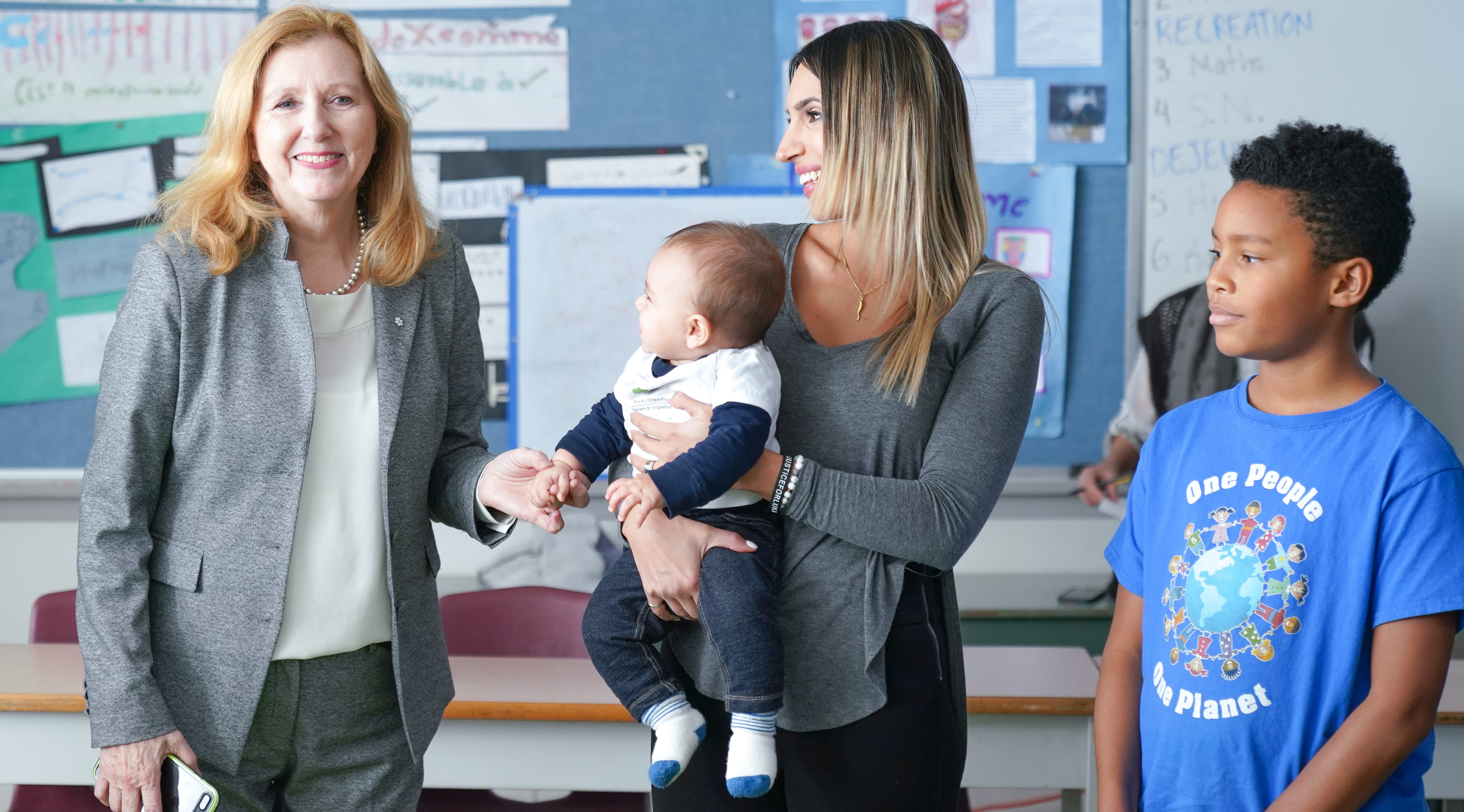 Mary Gordon, baby and mother, and a student in the classroom during a Roots of Empathy program